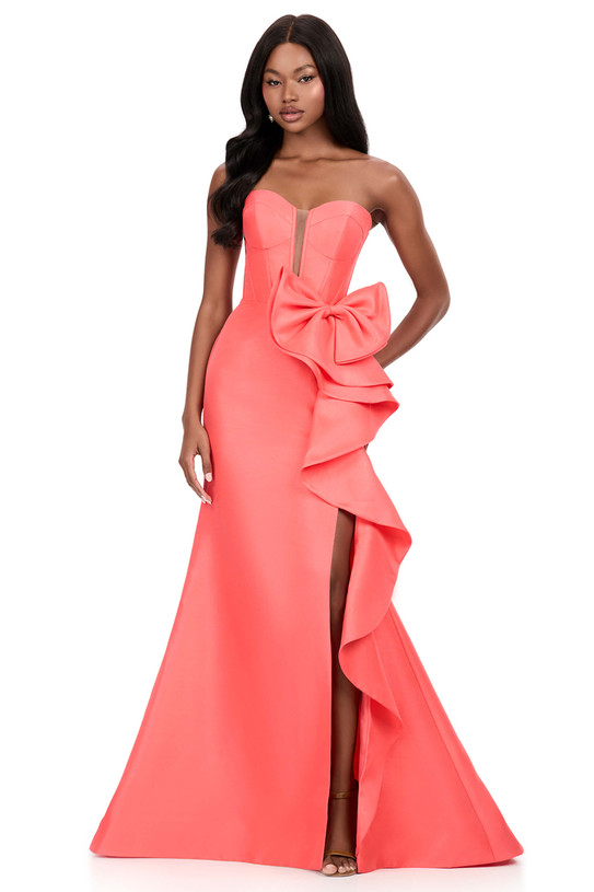 Ashley Lauren 12212 in Coral with oversized bow, cascading ruffle, and thigh-high slit.