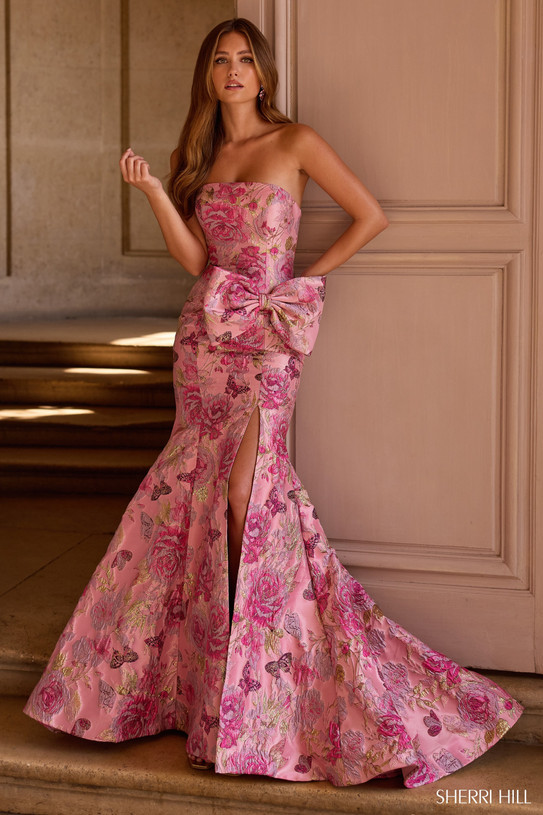 Sherri Hill 57762 in Rose Gold Print with strapless neckline, side bow accent, and dramatic slit.