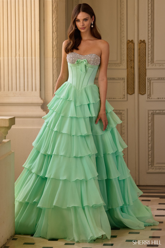 Sherri Hill 57799 in Light Green with beaded neckline, bow detail, and cascading ruffle tiers.