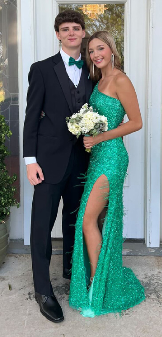 Couple in tux and green sequin dress with leg slit