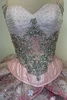 Beaded straps and open back of blush quinceañera ball gown