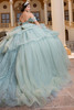 Mint glitter tulle ball gown with layered peplum, three-quarter back view