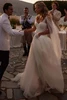 Bride wearing the Bellaria tulle wedding dress at an outdoor reception