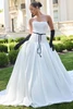 Front outdoor view of Adair satin ball gown styled with black gloves and belt accessories