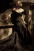 Angled view of Recine black satin dress with fit-and-flare skirt