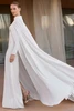 Back view of Neissia wedding gown with long sleeves and dramatic flowing detachable cape