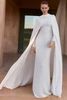 Front view of Pronovias Neissia long sleeve crepe column wedding dress with high neckline and detachable cape