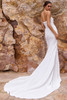 Back view of Nelani fitted crepe wedding gown with scattered floral appliqués and sweeping train