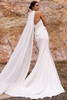 Back view of Rendra wedding dress with low back, fitted crepe silhouette and detachable cape