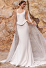 Front view of Pronovias Rendra crepe fit-and-flare wedding dress with sculpted peplum and chiffon cape