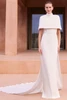 Front view of Pronovias Saideb column wedding dress with detachable capelet and cape