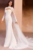 Front view of Pronovias Tzoe lace fit and flare wedding dress with bolero and cape