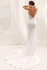 Back view of Zevia dress showing low open back and crepe train