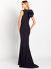Clean sheath silhouette flows to a gentle flare, framed by a dramatic shoulder rosette