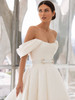 Off-shoulder ball gown with pleated sleeves and pearl-accented belt at the waist