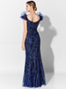 Sheer puff sleeves frame the V-back of this glittering fitted silhouette