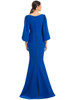 Buttoned back detail flows into a soft trumpet train for elegant exit drama