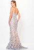 Back view reveals a flawless fit with shimmering silver appliqués trailing to the hem