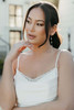 Detail view of 7915 dress showing draped scoop neckline and pearl strands