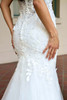 Detail view of 7924 dress with floral appliques over fitted skirt