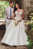 Plus-size bride wearing the Maggie Sottero Tina ball gown, highlighting the pearl-embellished Basque waist bodice.