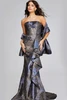 Black and gold Jovani gown with strapless bodice and dramatic side ruffle detail.