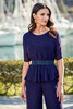 Close-up detail of jeweled belt and peplum overlay on chiffon jumpsuit
