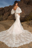 Back view of Kitty Chen Emma gown showing lace train and fitted silhouette with spaghetti straps and puff sleeves