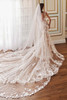 Back view of Martin Thornburg MT5108 gown with dramatic lace chapel train and sheer detailing.