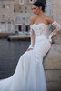 Detail shot of hem/train focusing on the lace appliqués cascading over tulle & the luxurious length of the gown.