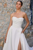 Detail view of the skirt and slit of Sophia Tolli Y3187, showing how the flow of satin meets the leg slit for dramatic movement.
