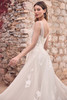 Side angle of Sophia Tolli Y3193 showing the illusion bodice, exposed boning, and lace appliqués trailing into the skirt