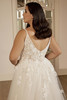 Side view of the Portrait by Enzoani Omarra gown showcasing glitter tulle and flowing organza layers.