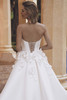 Bride in Udelia highlighting lace-up back and floral appliqués at waist.