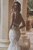 Bride in Urmila gown highlighting scoop back and curve-flattering silhouette.