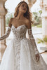 Bride sitting in Valen gown highlighting sweetheart neckline and embroidered lace bodice.