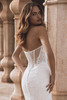 Side-back detail of Enzoani Veronika gown showing sheer corset boning and lace appliqués.