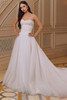 Front view of Morilee Rhiannon gown with lace appliqués and flowing overskirt.