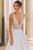 Bride wearing Rina with V-neckline and beaded lace bodice.