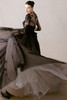 Morilee Chasse black gown back view with long train and sheer sleeves