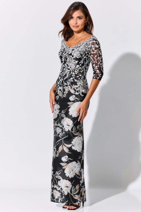 Ivory embroidery climbs over sheer sleeves and a sleek black column silhouette Ivory embroidery climbs over sheer sleeves and a sleek black column silhouette