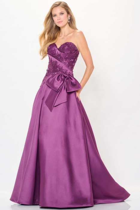 Rich purple satin gown features a lace-wrapped bodice and bold side bow for dramatic charm