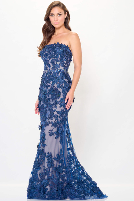 Bold navy gown blooms with intricate 3D floral embroidery and a figure-hugging silhouette Bold navy gown blooms with intricate 3D floral embroidery and a figure-hugging silhouette