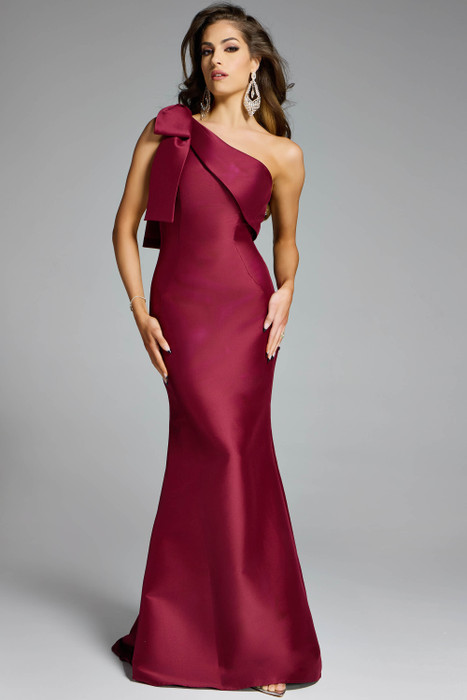 Jovani 43361 one-shoulder burgundy gown with oversized bow and sleek mermaid silhouette.