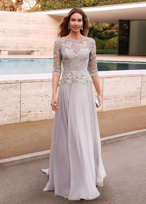 Front view of Alyce Paris MOB gown 27470 in Silver featuring illusion bateau neckline, lace peplum, and flowy chiffon A‑line skirt Front view of Alyce Paris MOB gown 27470 in Silver featuring illusion bateau neckline, lace peplum, and flowy chiffon A‑line skirt
