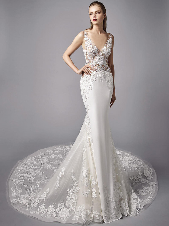 Sheer lace bodice meets sleek silhouette and finishes in a dramatic embroidered cathedral train Sheer lace bodice meets sleek silhouette and finishes in a dramatic embroidered cathedral train