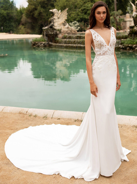 Plunging V-neck gown with illusion lace bodice, crepe skirt, and elegant sweeping train Plunging V-neck gown with illusion lace bodice, crepe skirt, and elegant sweeping train