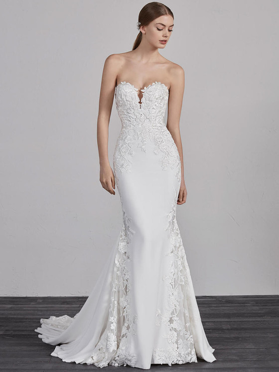 Strapless fit-and-flare gown with plunging neckline, lace appliqués, and soft flared godets Strapless fit-and-flare gown with plunging neckline, lace appliqués, and soft flared godets
