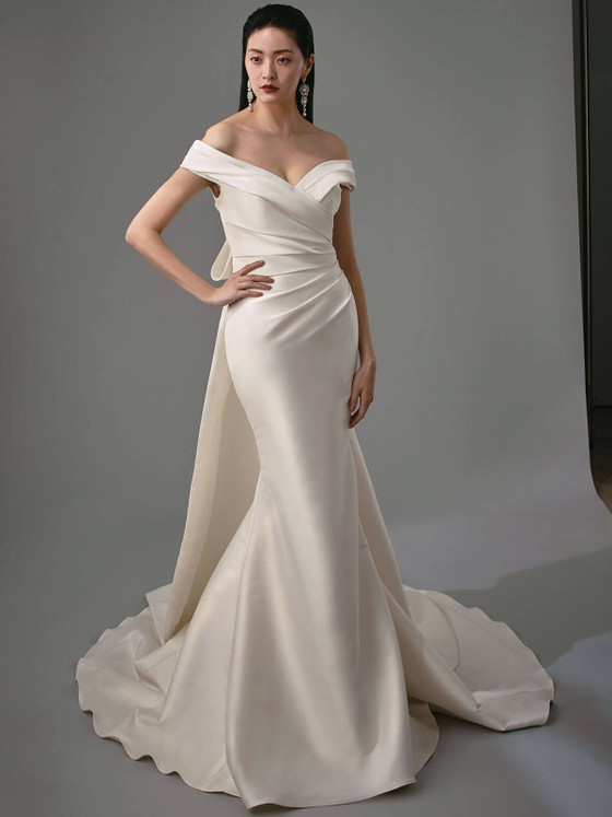 Sophisticated off-shoulder draped bodice, finished with sweeping train and bow streamers Sophisticated off-shoulder draped bodice, finished with sweeping train and bow streamers