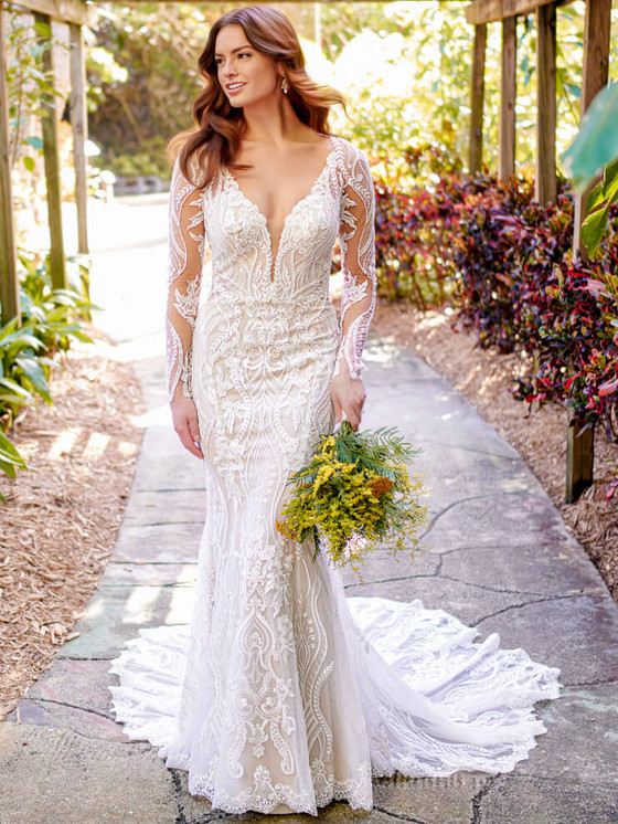 Bold lace patterns and illusion sleeves define this fitted gown with a stunning cathedral train Bold lace patterns and illusion sleeves define this fitted gown with a stunning cathedral train